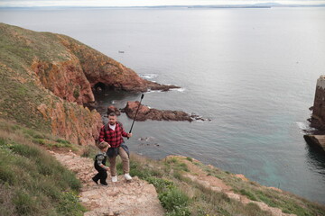Father and son exploring coastal island trail together