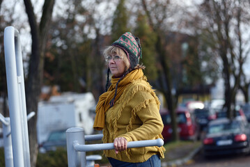 Active senior woman exercising outdoors in an autumn park
