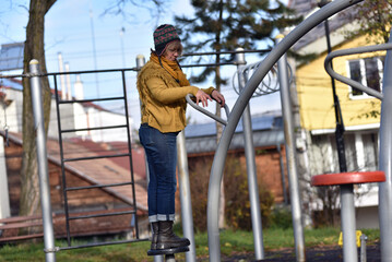 Active senior woman exercising outdoors in an autumn park