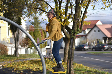Active senior woman exercising outdoors in an autumn park