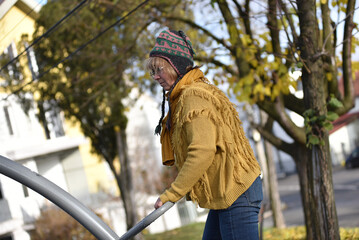Active senior woman exercising outdoors in an autumn park