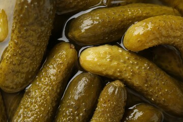 Pickled cucumbers in brine as background, closeup