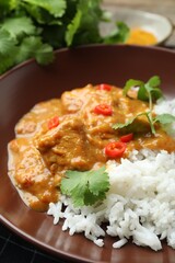 Chicken tikka masala with rice served on table, closeup