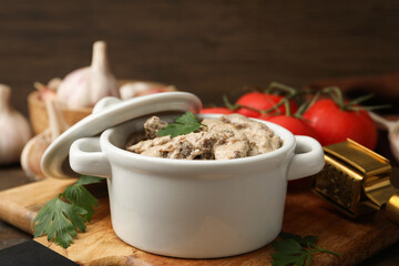 Tasty beef stroganoff with parsley served on wooden table, closeup