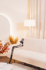Podcast setup featuring a stylish microphone on a modern couch in a cozy studio environment