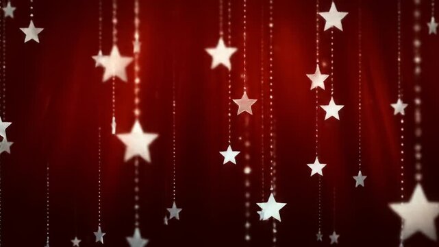 Numerous soft white stars dangle against a deep red, velvety backdrop