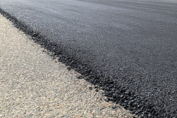 Naklejka premium Road construction with freshly laid asphalt and smooth surface providing durability and safety