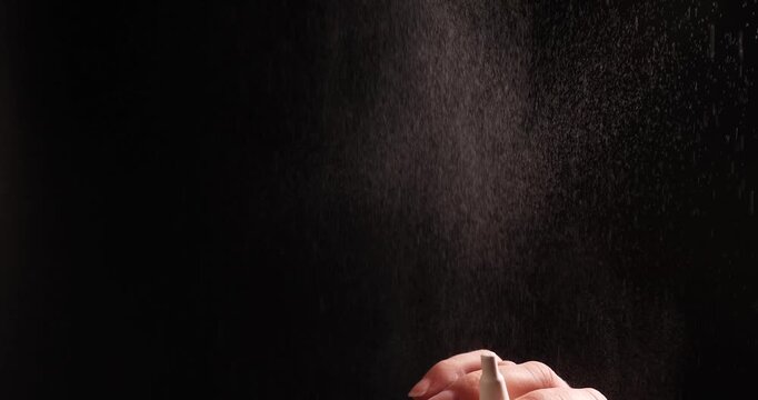 A hand repeatedly uses a nasal spray. The spraying of the vasoconstrictor drug shows excessive use, illustrating the concept of nasal spray addiction.