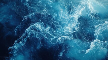 A dramatic, close-up image captures the turbulent energy of a powerful ocean wave, rendered in deep shades of blue and white.
