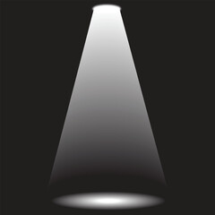 A soft glow and dramatic lighting effect are produced by a white spotlight beam shining on a dark black stage background.