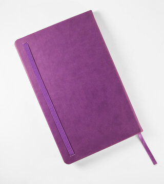 Top view purple notebook mockup on bright white surface