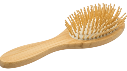 A close up of a wooden hairbrush with light brown bristles on a black isolated background image