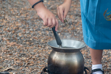 Junior Red Cross students making jungle curry during their outdoor camping trip.