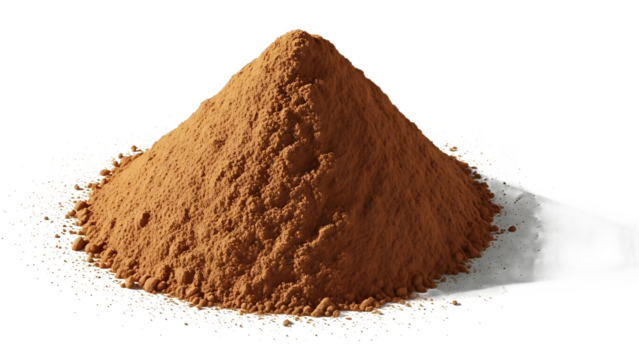 A mound of brown powder on a white surface with a dark shadow behind it in a studio setting