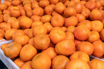 Fresh oranges on market stand. Concept of healthy lifestyle and natural vitamin source symbolizing freshness, abundance, and sustainable nutrition.
