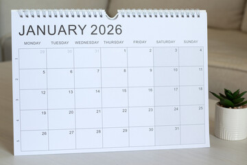 Calendar for January 2026 on a table. Close-up. Annual planning, business goals, weekly organizer concept.