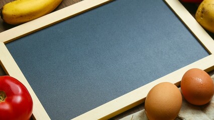 Blank chalkboard with fresh ingredients for cooking and baking