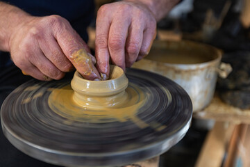 Skilled Potter Shaping Clay on a Wheel