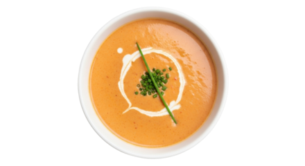 Isolated tomato soup garnished with cream and chives ready to serve, overhead view