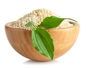 Bowl of tiny grains adorned with green leaves and a small white flower, isolated against a white background