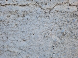Texture of old rustic wall covered with gray stucco plaster