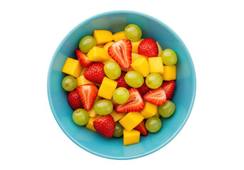 Isolated healthy fruit salad of ripe mango, strawberries, and grapes in a blue bowl
