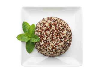 Isolated mixed quinoa mound on a plate, decorated with fresh mint for a healthy meal