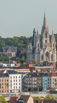 Aerial morning view of Notre Dame de Laeken church spires timelapse in Brussels, Belgium. Neo-gothic architecture surrounded by historic facades, lush green park areas and picturesque urban scenery