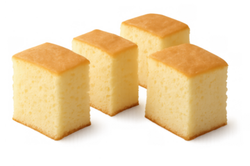 Four square cuts of traditional japanese castella sponge cake, showing golden-brown crust and moist, airy interior, ready to serve