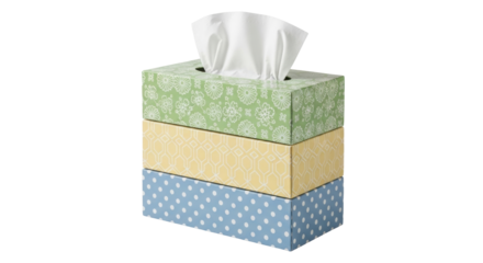 Isolated stack of three patterned rectangular boxes containing soft facial tissue or napkins