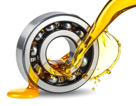 Bearing receives cascading, golden oil against a white background, lubrication in action
