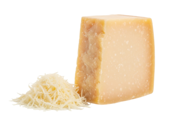 Isolated block of aged Parmesan cheese with grated cheese shreds alongside, close-up view