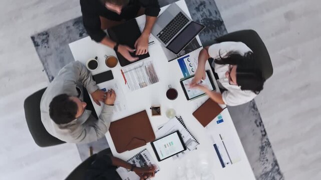 Above, research and team with business people in meeting for planning, budget discussion or documents. Account analysis, risk management and collaboration with employees and tech in agency for report