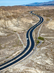 Cutting Through the Arid Landscape: Aerial View of the Highway Crossing the Desolate Tabernas...