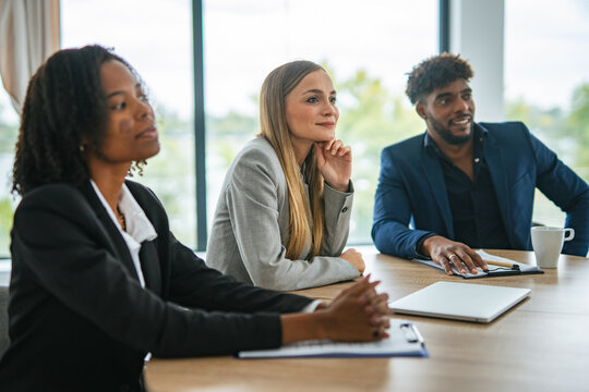 Diverse business professionals having discussion in corporate meeting room