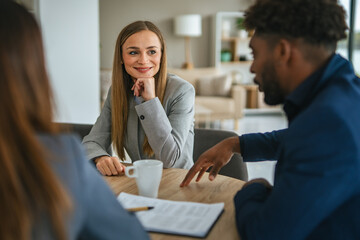 Financial adviser meeting diverse clients discussing future planning