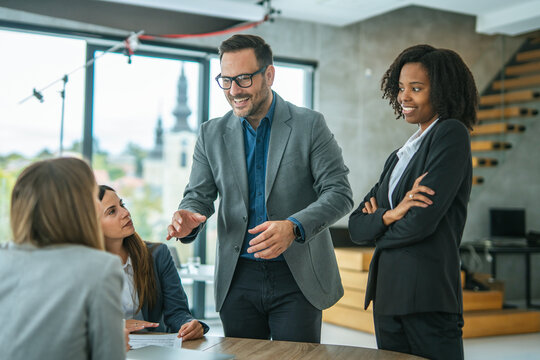 Business professionals collaborating at a corporate office meeting - Powered by Adobe