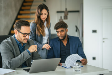 Diverse business team collaborating on project in office