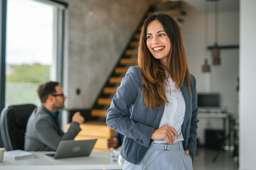 Professional businesswoman smiling confidently in modern office setting