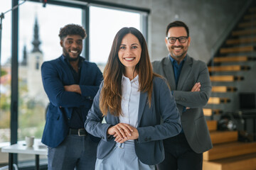 Diverse business team smiling with crossed arms in office