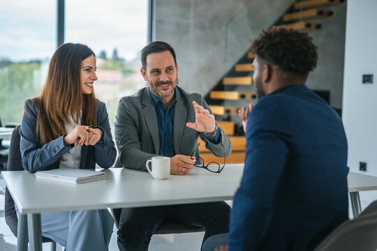 Recruiters interviewing male job candidate during hiring process