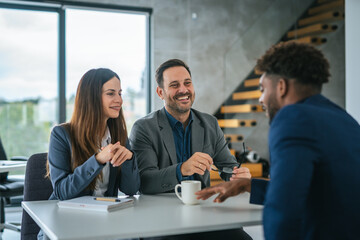 Business professionals discussing work at an office meeting