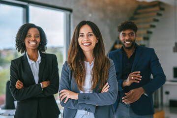 Diverse business team smiling confidently in modern office