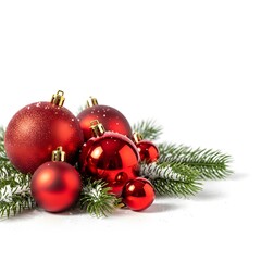 A festive corner arrangement of vibrant red Christmas baubles and a snow-dusted fir branch isolated on a clean white background