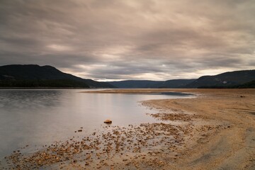 Obraz premium view of the beach and Fyresvatn Lake in Telemark County just before sunset