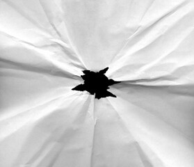 Black hole in crumpled paper with torn edges