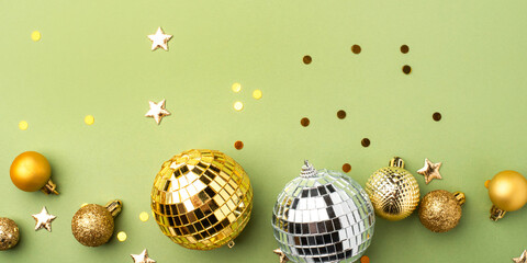 Festive Christmas gold ornaments on a green background.