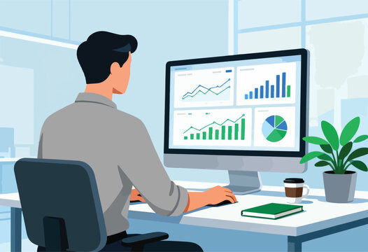 An individual, from the back, works at a desk, looking at a computer screen displaying graphs and charts