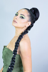 Beautiful European woman getting artistic makeup applied by a professional makeup artist in a modern beauty salon, beauty and elegance concept.