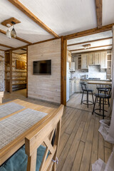 Fototapeta premium Bright Rustic Living Room and Kitchen Interior with Wooden Furniture